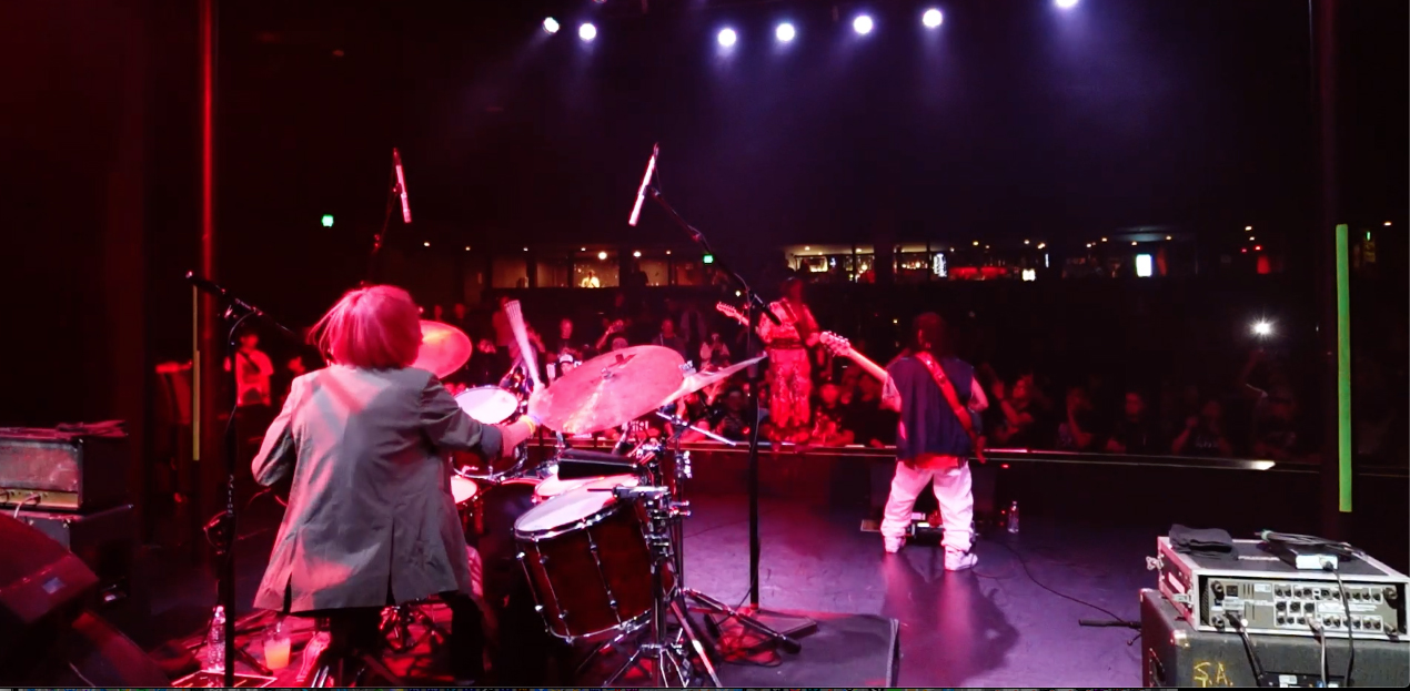 ASTERISM Band. From left to right: MIO, HAL-CA, and MIYU. Photo captured from live footage provided by Sony Music Entertainment Japan (SMEJ)