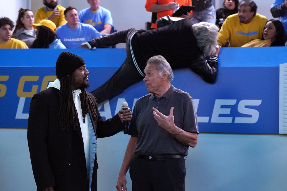 LOPEZ VS LOPEZ -- "Lopez vs Raider Nation" Episode 205 -- Pictured: (l-r) Marshawn Lynch as Himself, Jim Plunkett as Himself -- (Photo by: Nicole Weingart/NBC)