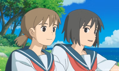 Mayu and San in sailor uniforms side by side against a blue sky and sea.