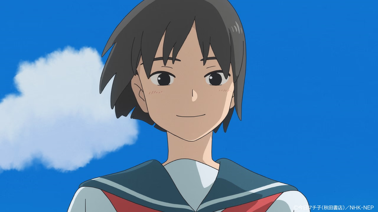 Close-up of San smiling against a bright blue sky with a single white cloud.