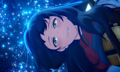 Inako smiling, surrounded by glittering blue sparks.