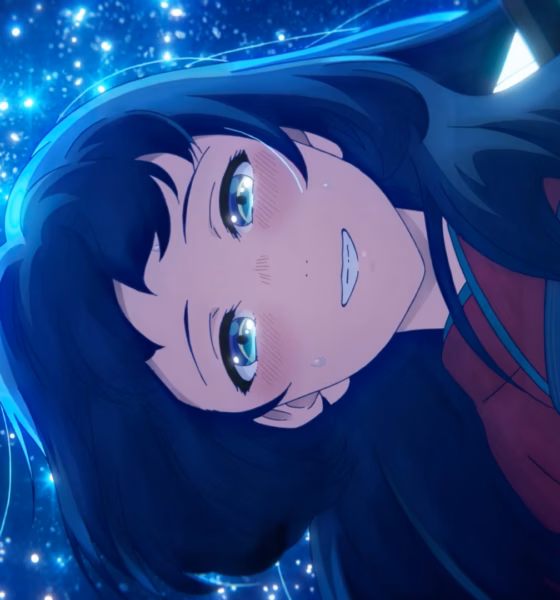 Inako smiling, surrounded by glittering blue sparks.