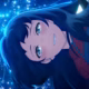 Inako smiling, surrounded by glittering blue sparks.