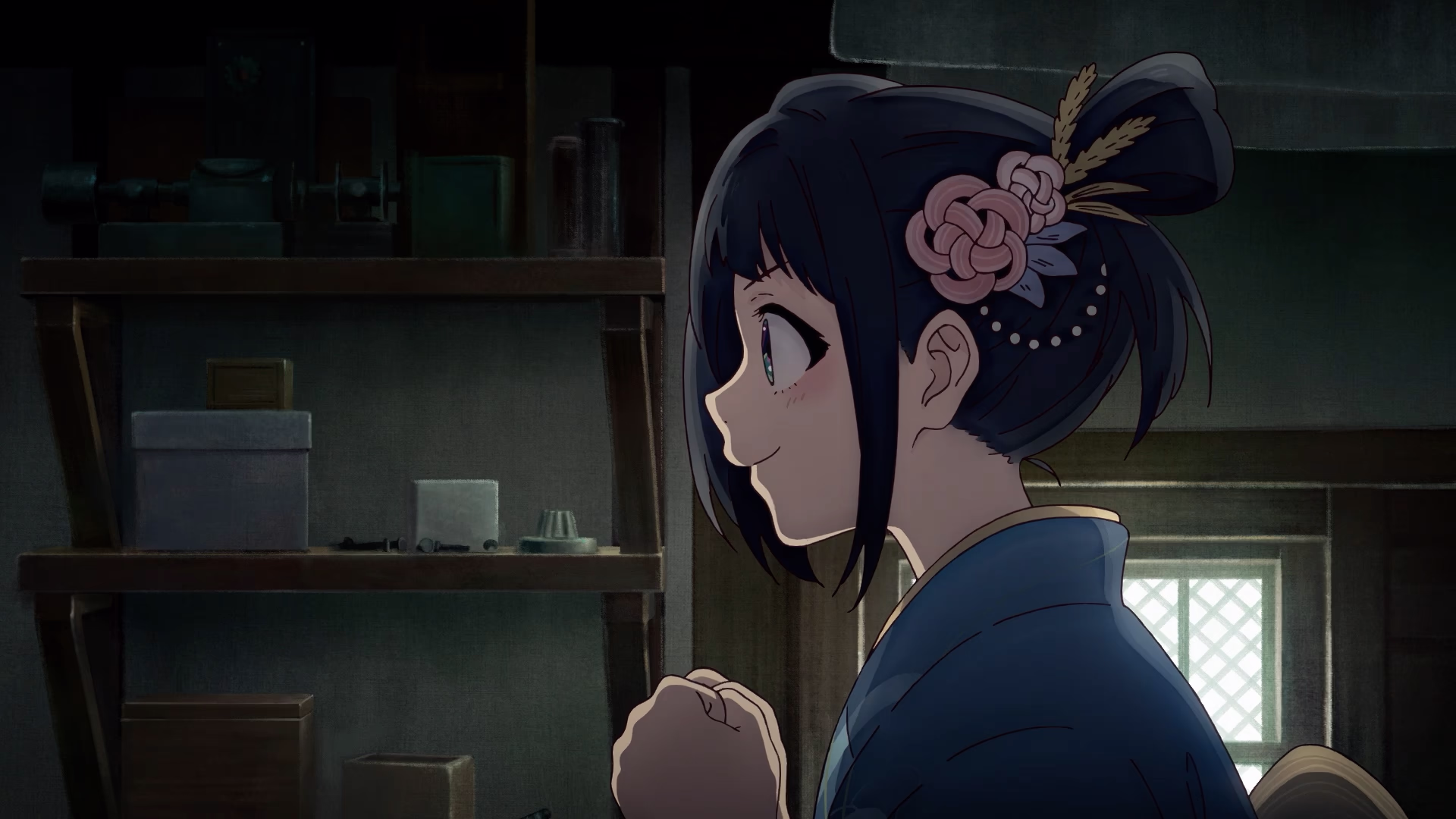 Profile of Inako smiling softly in a dark workshop.